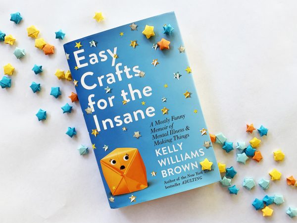 Image of the book Easy Crafts for the Insane by Kelly Williams Brown surrounded by yellow, blue and orange origami paper stars